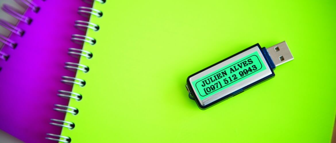 Memoria USB etiquetada encima de cuadernos